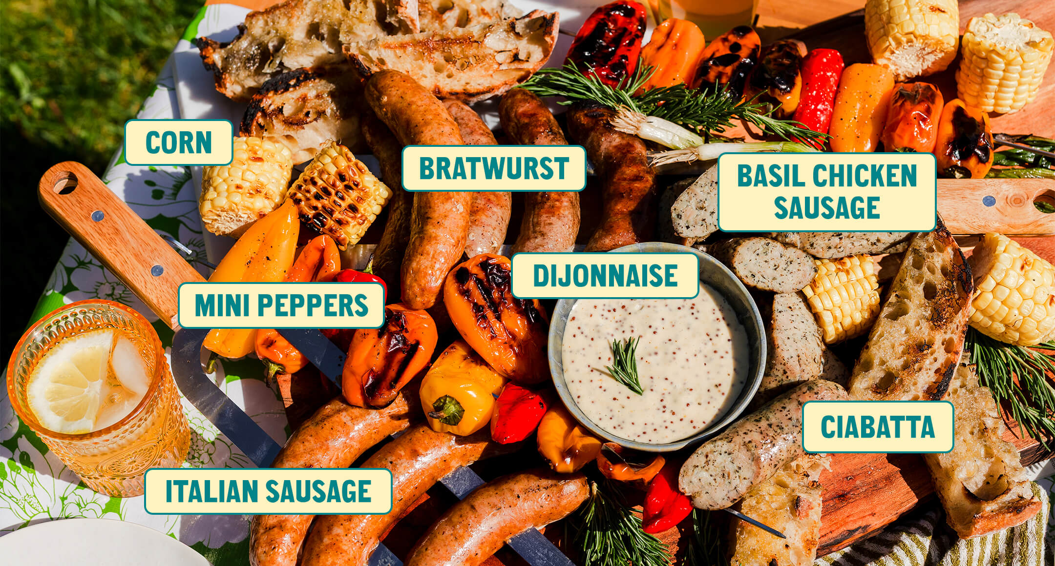 A sausage board featuring brats, Italian sausage, Basil Chicken sausage and a Dijon dipping sauce.